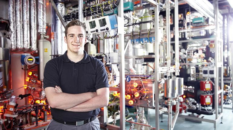 Young man in front of machines