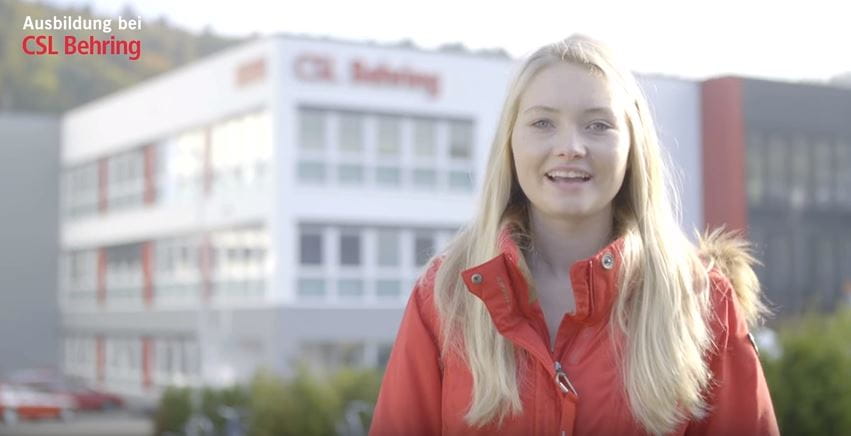 woman in front of production building